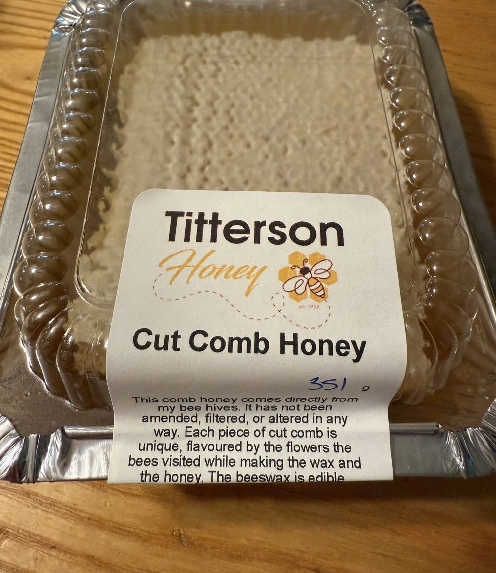 A tray of Titterson cut comb honey, weighed and labelled by hand.